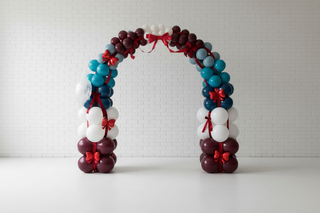 Balloon archway with red ribbons 