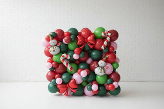 Colorful balloon arrangement with Christmas-themed decorations.