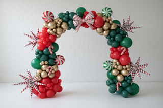 Decorative balloon arch with red, green, and gold balloons