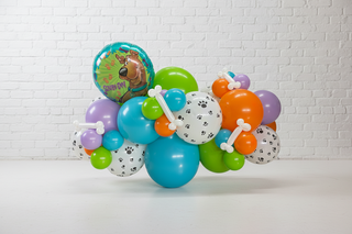 A garland featuring round balloons in various colors and a character balloon resembling Scooby Doo.