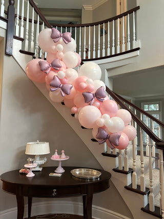 Pink bow garland balloon installation with the 99 Haus Balloons and Decor custom event service