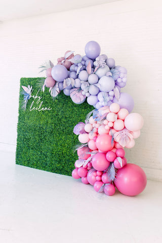 Boxwood backdrop with custom tropical balloons installation with the 99 Haus Balloons and Decor custom event service