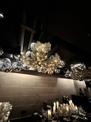 Chrome orbs and floral ceiling wedding event decor with the 99 Haus Balloons and Decor custom event service