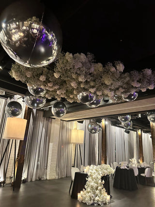 Chrome orbs and floral ceiling wedding event decor with the 99 Haus Balloons and Decor custom event service