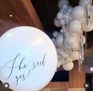 Engagement party balloon decor and ceiling installation with metallic silver fringe