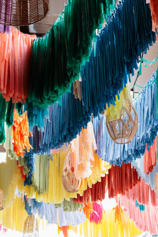 Rainbow fringe corporate decor installation with the 99 Haus Balloons and Decor custom event service