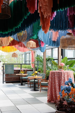 Rainbow fringe corporate decor installation with the 99 Haus Balloons and Decor custom event service