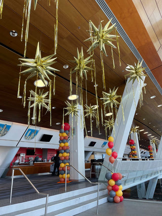 Golden star ceiling corporate balloon installation with the 99 Haus Balloons and Decor custom event service