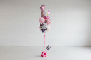 Hello Kitty balloons in a white room