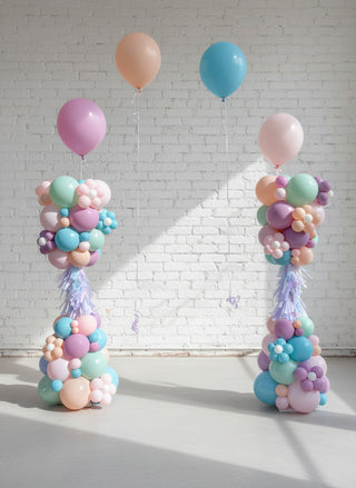 Two columns of Easter-themed balloons in pastel colors with decorative elements, intended as part of a helium arch decoration setup.