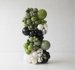 Balloon sculpture with green, black, and white balloons 