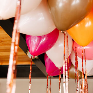 Colorful balloons with tassels hanging from a ceiling
