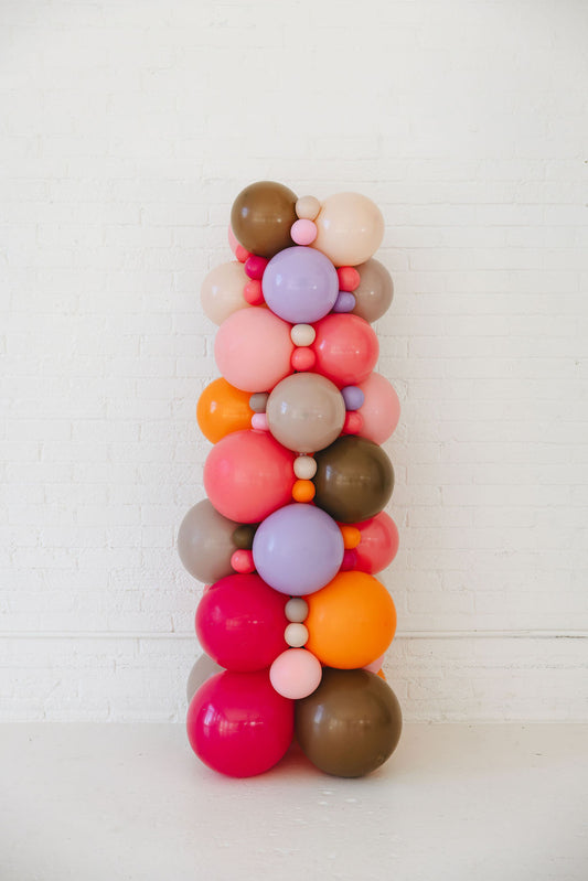 Colorful balloon arch on a white background
