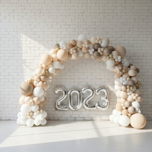 A balloon arch featuring a collection of latex and foil balloons, arranged organically in an indoor setting. 