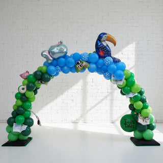 A balloon arch featuring a collection of latex and foil balloons, arranged organically in an indoor setting. 