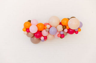 Colorful balloon arch on a white background
