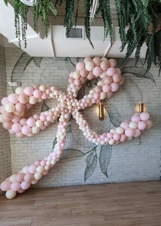 Pink bow balloon installation with the 99 Haus Balloons and Decor custom event service