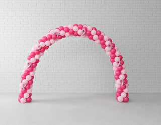 a breast cancer awareness themed pink spiral arch