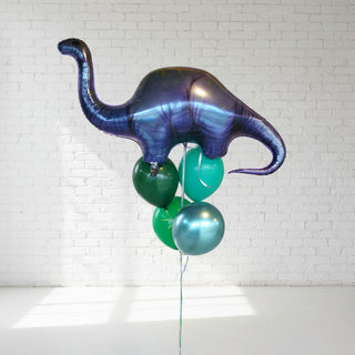 A helium balloon bouquet featuring a large dinosaur shape with smaller round balloons in shades of green and blue, positioned against a light background.