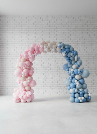 A balloon arch with a gradient of pink to blue, suitable for gender reveal parties.