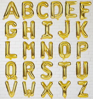 Gold letter balloons spelling out the alphabet on a white background