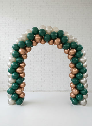 a green, gold, and pearl colored balloon arch