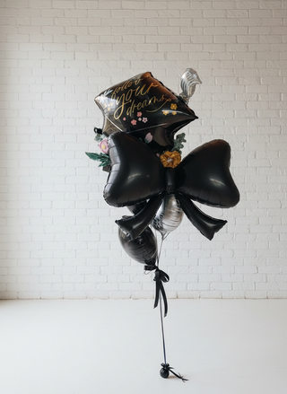 A helium graduation themed bouquet