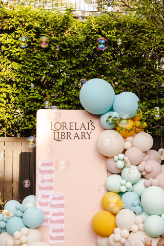 A library themed backdrop with pastel colors