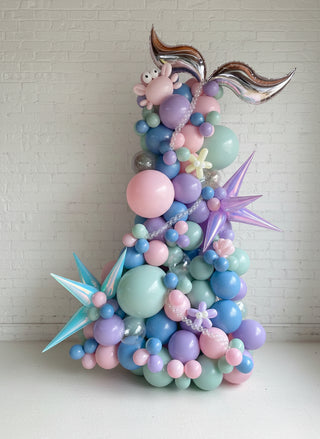 A decorative garland featuring a variety of balloons in shades of blue and pink, designed to resemble sea creatures and seaweed for a themed party decoration.