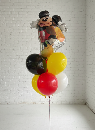 A helium bouquet featuring character balloons and colorful round balloons in red, yellow, and black, assembled to form a Mickey Mouse figure.