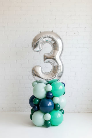 a balloon column topped with the number three