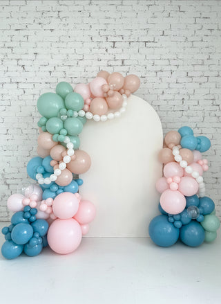 A blue and pink backdrop with pearl accents