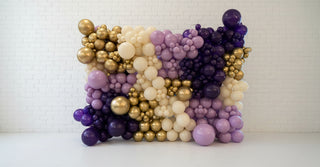 a purple and gold balloon wall