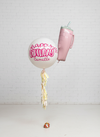 a jumbo balloon with a stanley cup foil balloon attached