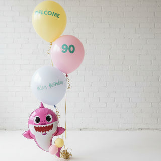 A shark cutout with a helium balloon trip